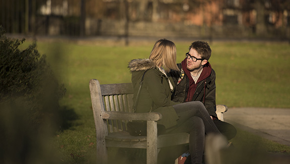 man-observing-stoma-pouch-on-his-abdomen-thinking-about-body-image-concerns-with-a-stoma
